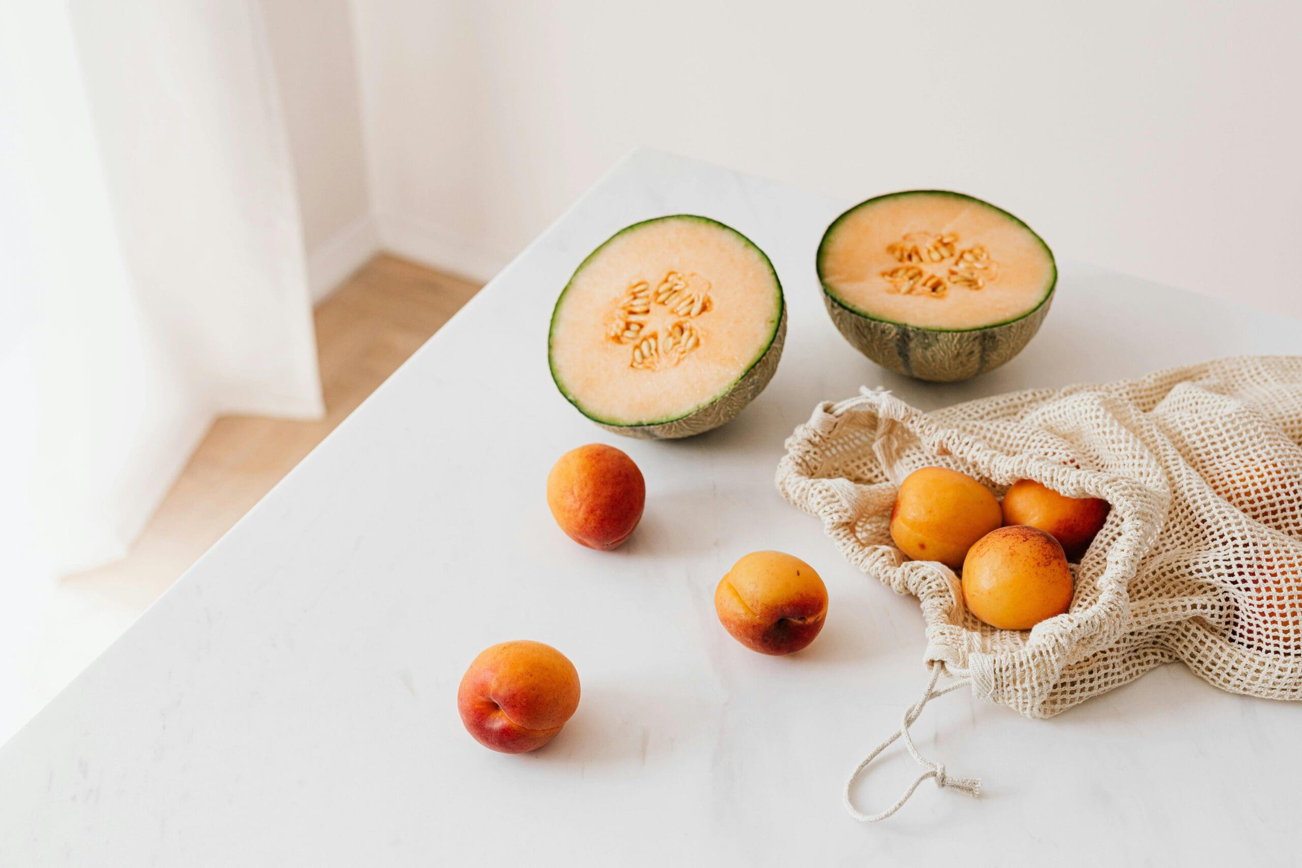 Healthy fruits on a white counter representing hormone-supported weight loss and GLP-1 therapy